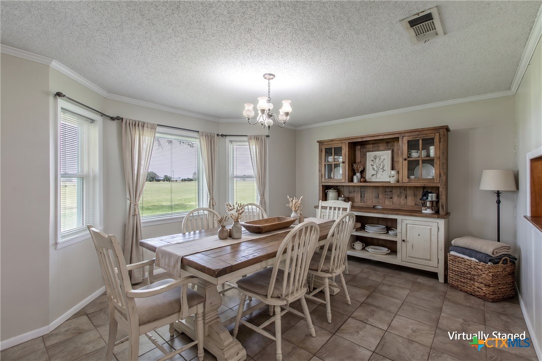 3053 Hobby Creek Road Burlington, TX 76519 - Photo 16 of 40 a view of a dining room with furniture and chandelier