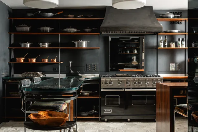 a stove top oven sitting inside of a kitchen
