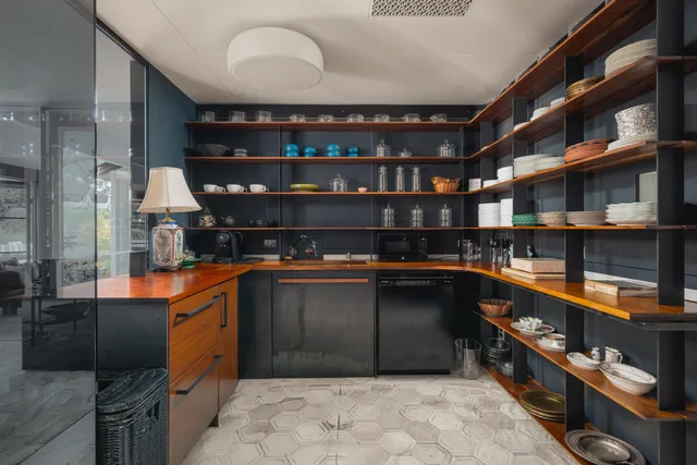 a kitchen with stainless steel appliances kitchen island granite countertop a refrigerator and a stove