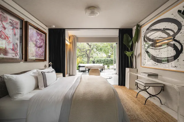 a bedroom with furniture and a large window