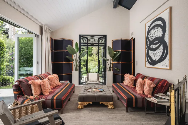 a bedroom with furniture and a window