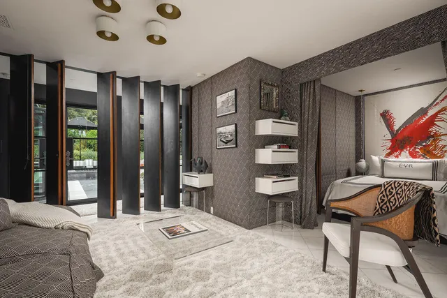 a bedroom with a bed and a chandelier