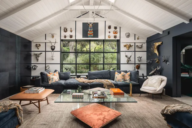 a living room with furniture and a floor to ceiling window