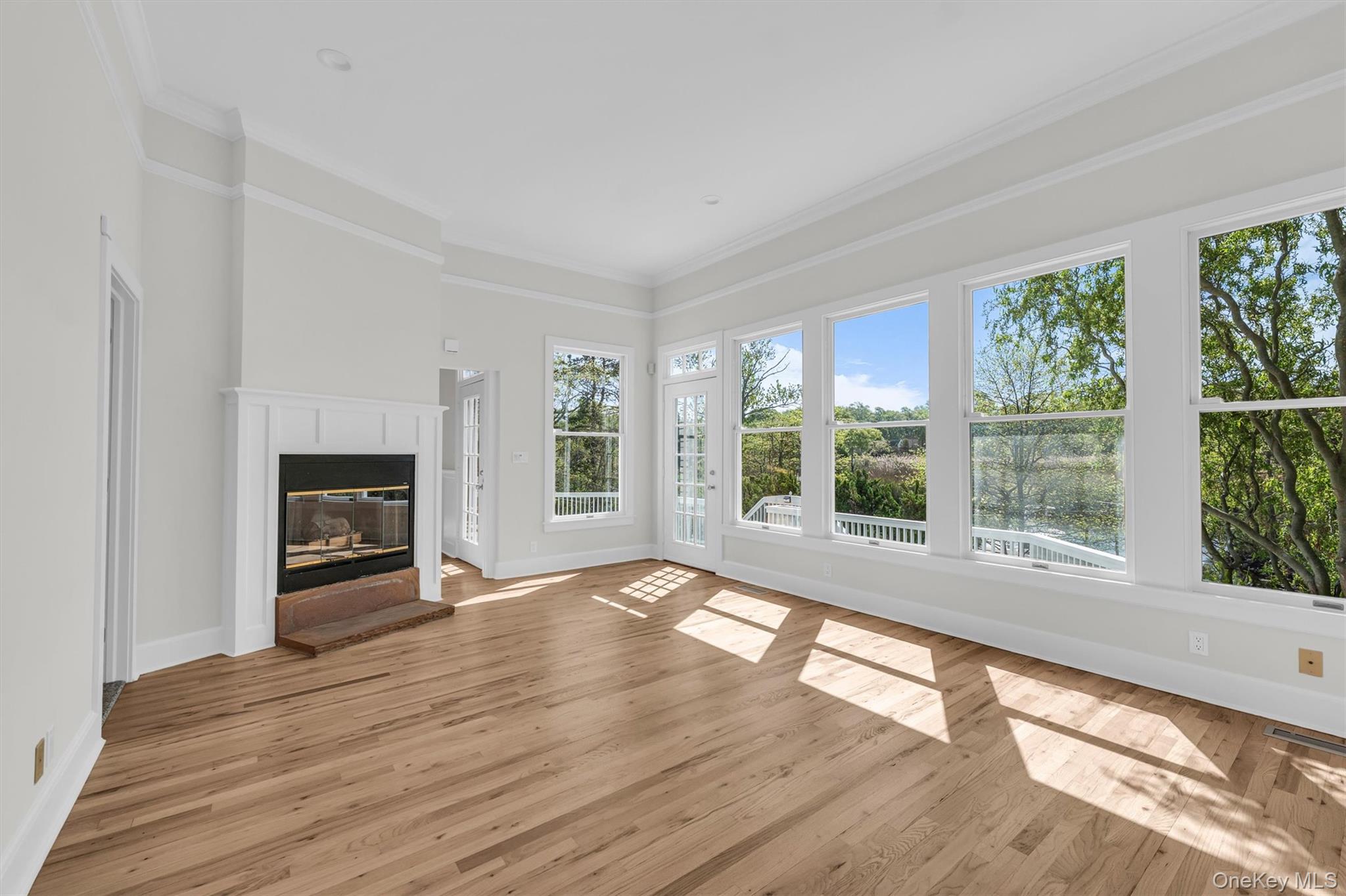 238 Beaver Dam Road Brookhaven, NY 11719 - Photo 21 of 44 a view of an empty room with wooden floor and a window