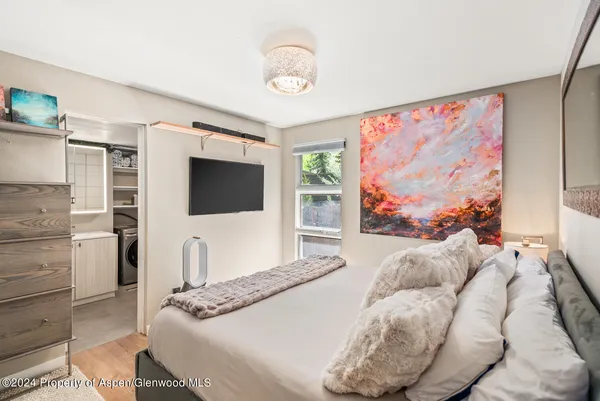 a bedroom with a bed and a flat screen tv