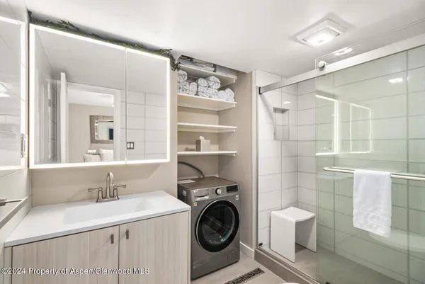 a bathroom with a sink a toilet and a shower