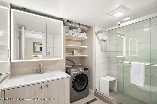 a bathroom with a sink a toilet and a shower