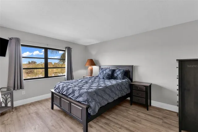 a bedroom with a bed and window