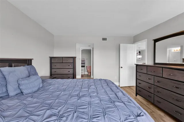 a bedroom with a large bed and a dresser