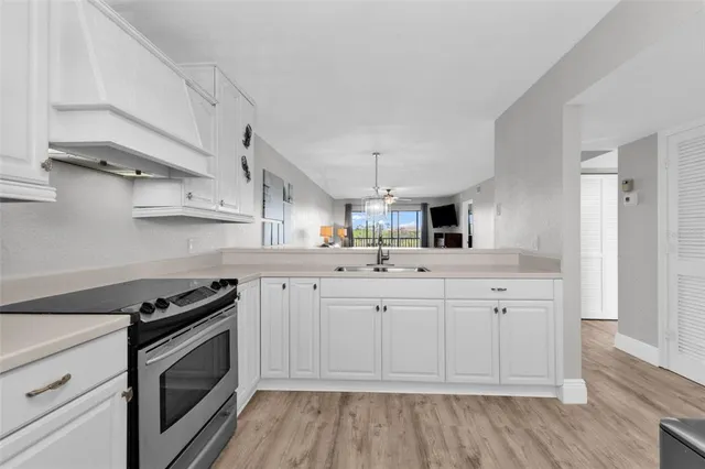 a kitchen with stainless steel appliances a stove microwave and cabinets