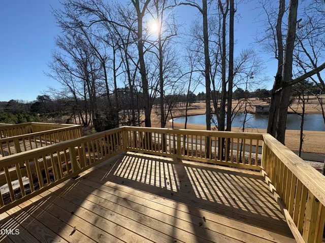 a view of balcony with wooden floor and fence
