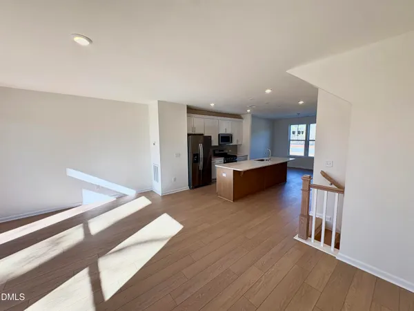 a view of a kitchen with a sink and a refrigerator