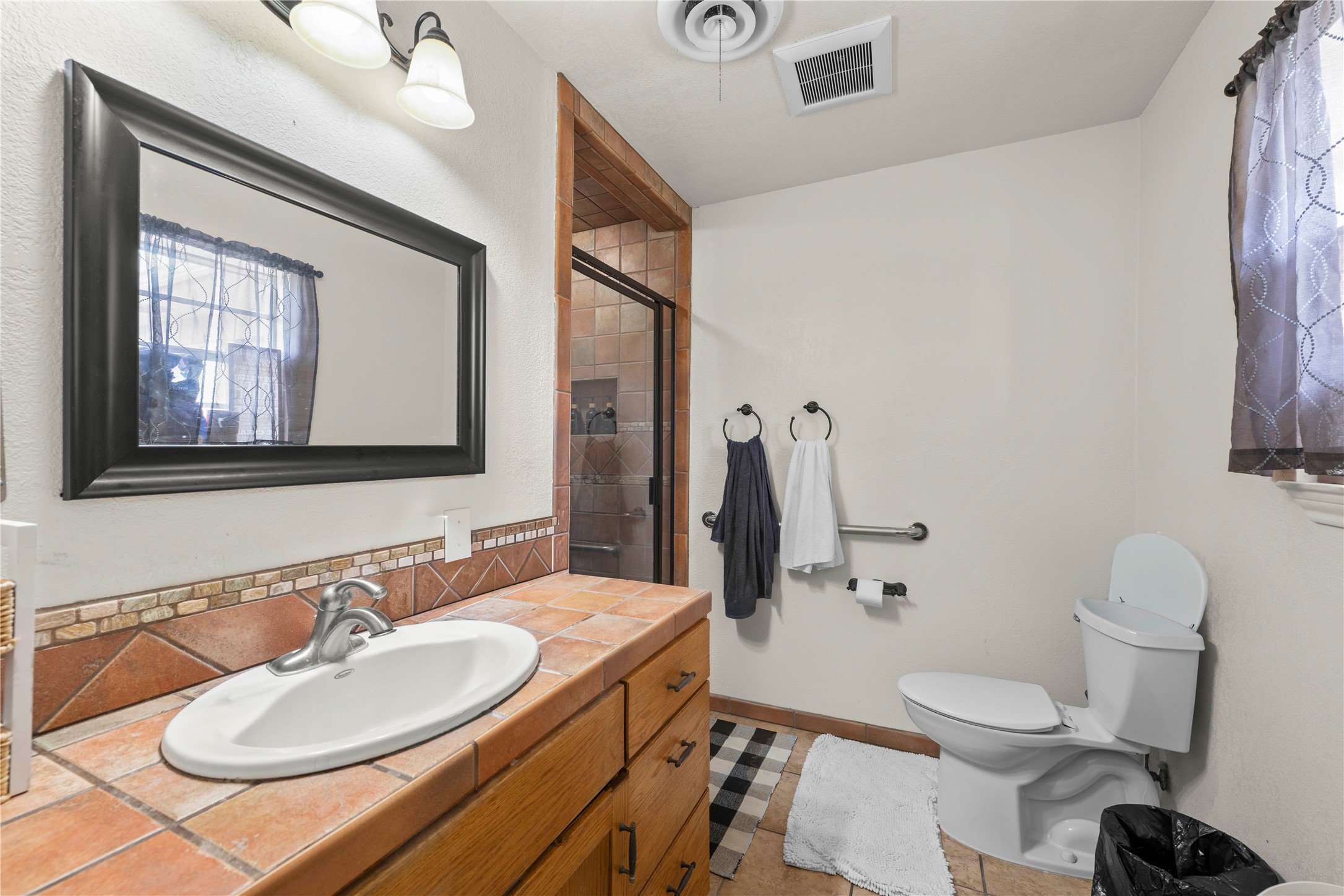 2915 County Road 153 Georgetown, TX 78626 - Photo 18 of 24 a bathroom with a granite countertop sink mirror vanity and toilet