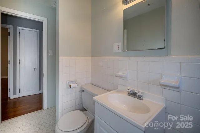 a bathroom with a sink toilet and mirror