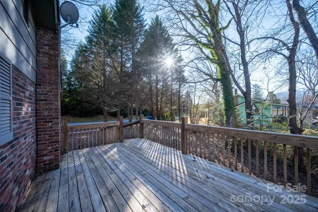 a view of balcony with wooden floor and fence