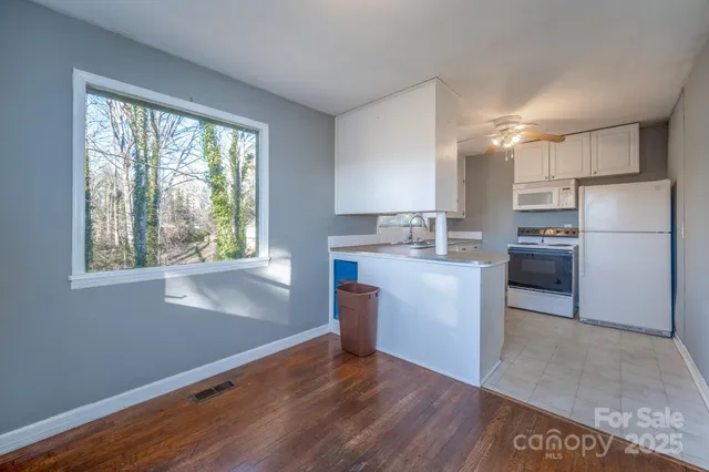 a kitchen with a refrigerator and a stove