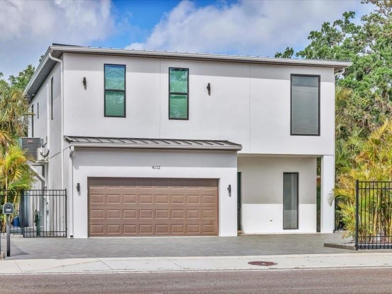 a view of a house with a garage and balcony