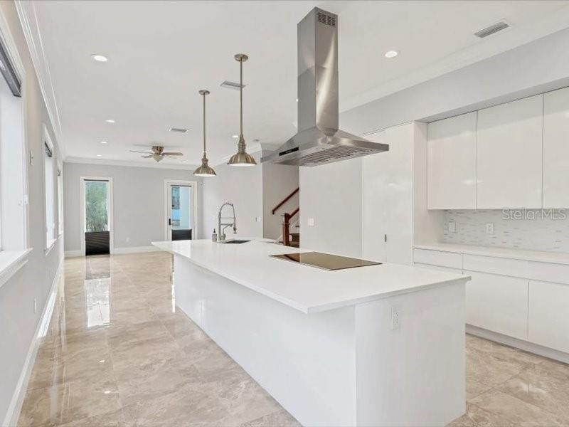 4112 Swift Road Sarasota, FL 34231 - Photo 13 of 41 a large kitchen with kitchen island a sink stainless steel appliances and cabinets