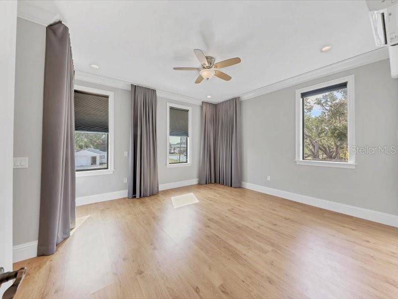 4112 Swift Road Sarasota, FL 34231 - Photo 22 of 41 an empty room with windows and fan