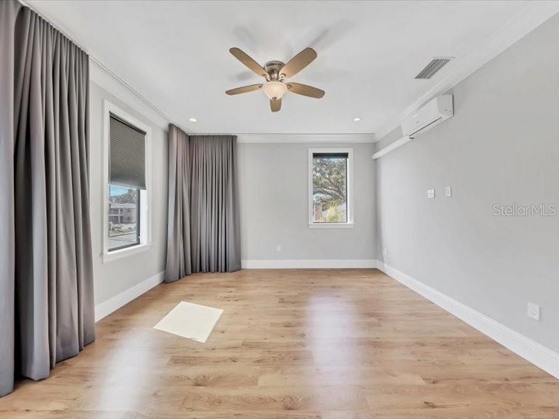 4112 Swift Road Sarasota, FL 34231 - Photo 23 of 41 a view of an empty room with window and wooden floor