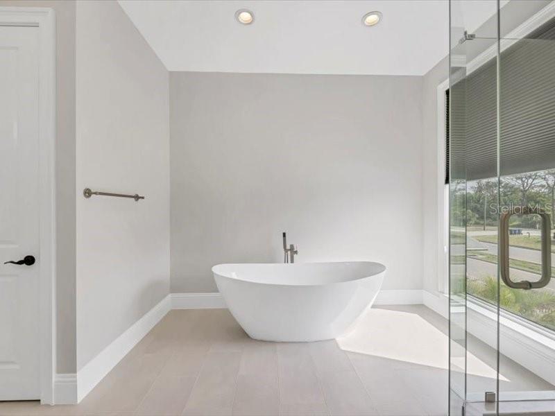 4112 Swift Road Sarasota, FL 34231 - Photo 25 of 41 a bathroom with a white tub shower and sink