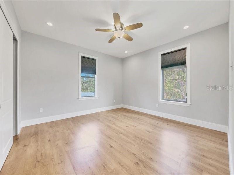 4112 Swift Road Sarasota, FL 34231 - Photo 28 of 41 an empty room with wooden floor ceiling fan and windows