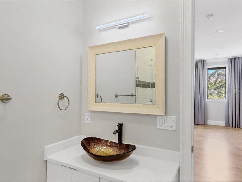 4112 Swift Road Sarasota, FL 34231 - Photo 30 of 41 a bathroom with a sink and a mirror