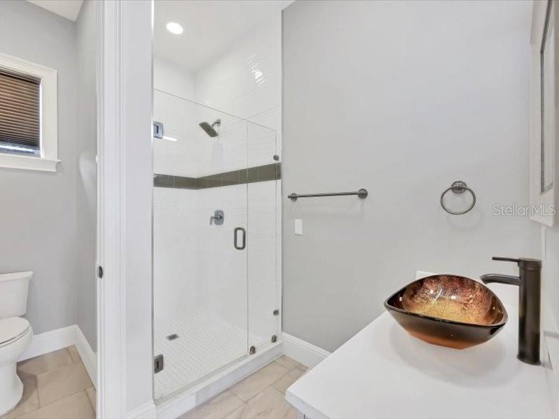 4112 Swift Road Sarasota, FL 34231 - Photo 31 of 41 a bathroom with a mirror and a shower