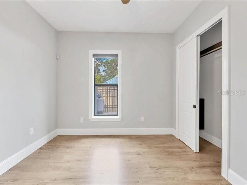4112 Swift Road Sarasota, FL 34231 - Photo 34 of 41 an empty room with wooden floor and windows