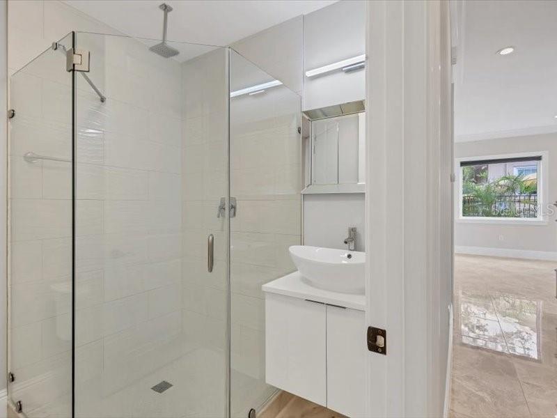 4112 Swift Road Sarasota, FL 34231 - Photo 36 of 41 a bathroom with a sink a mirror and shower