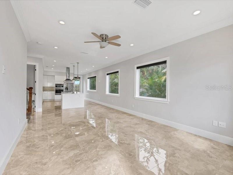 4112 Swift Road Sarasota, FL 34231 - Photo 4 of 41 a view of open kitchen with kitchen island a stove a refrigerator a sink dishwasher with a dining table and chairs with wooden floor