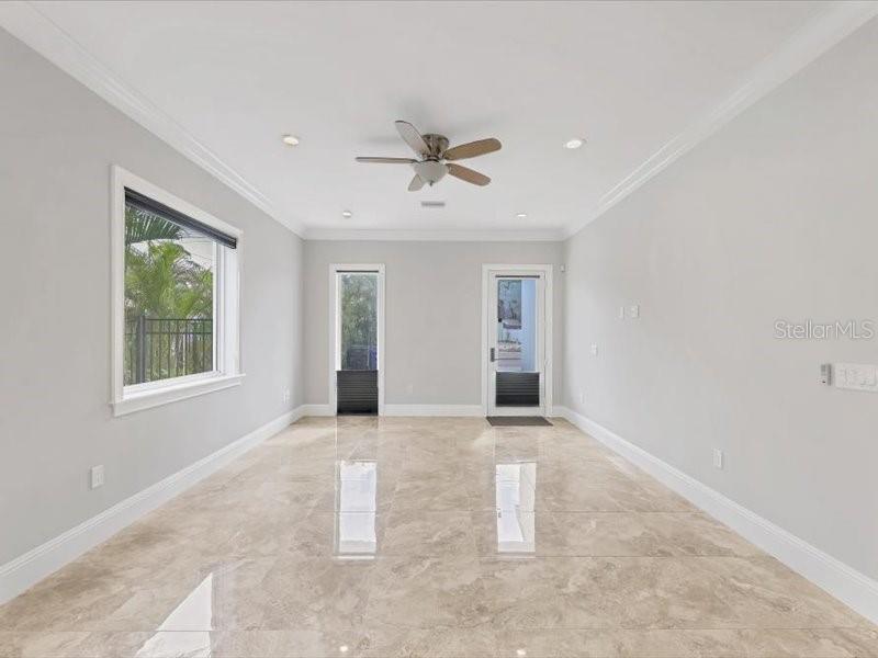 4112 Swift Road Sarasota, FL 34231 - Photo 6 of 41 an empty room with windows and fan