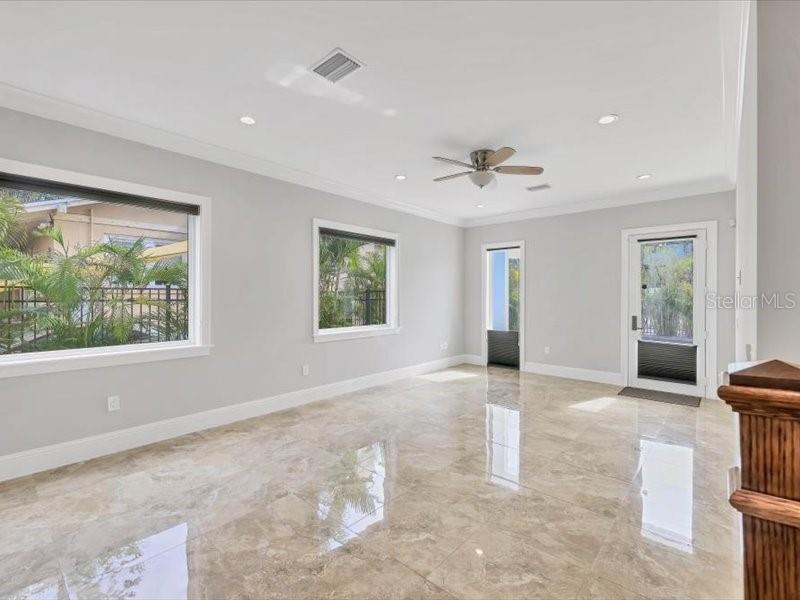 4112 Swift Road Sarasota, FL 34231 - Photo 7 of 41 an empty room with windows and ceiling fan