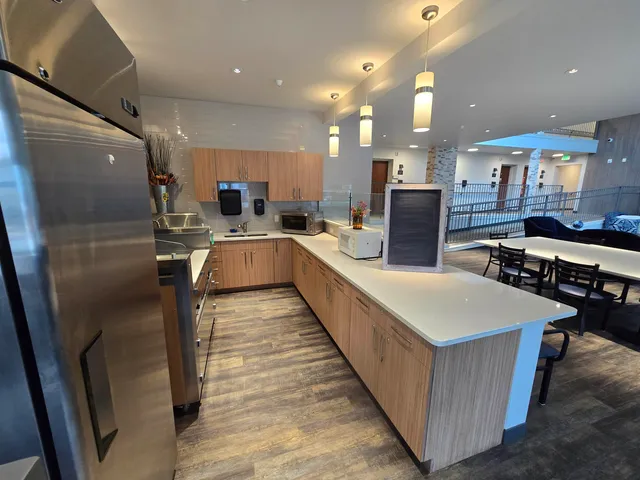a living room with dining room and wooden floor