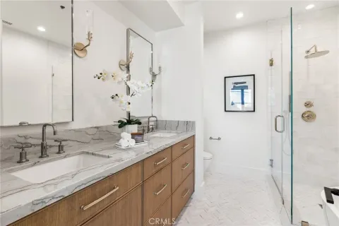 a bathroom with a granite countertop sink mirror and double