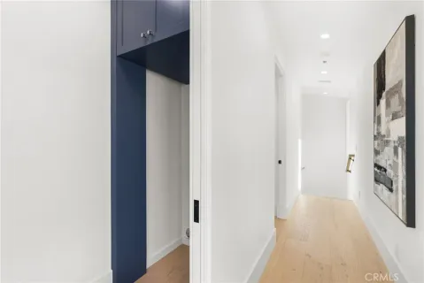 a view of a hallway with a refrigerator