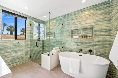 a bathroom with a double vanity sink toilet and shower