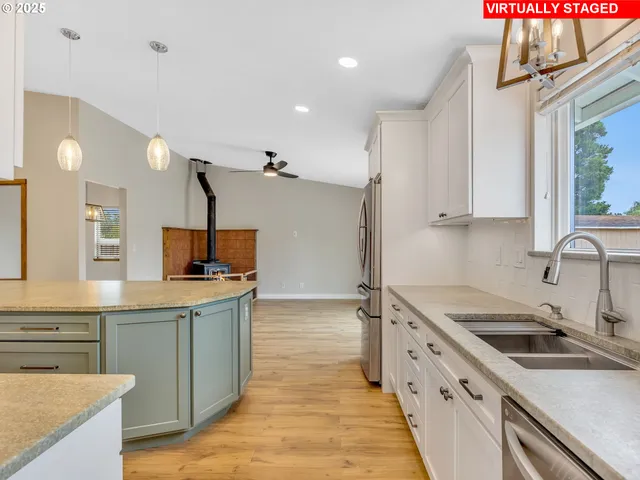 a kitchen with a sink stove top oven and refrigerator