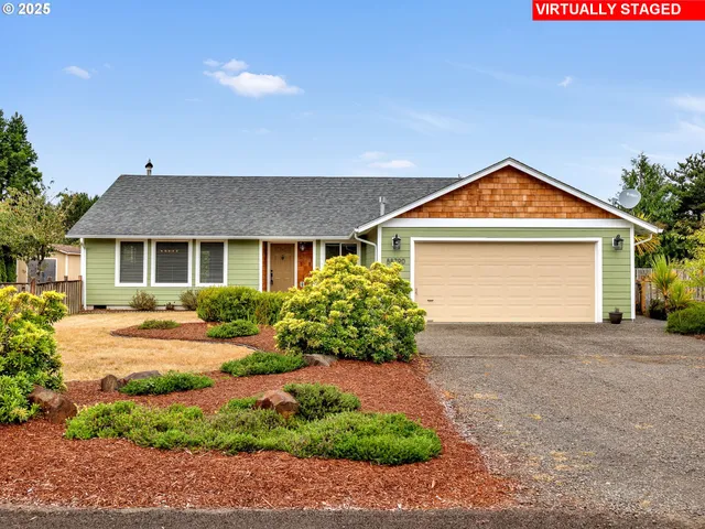 a front view of a house with a garden and yard