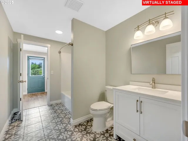 a bathroom with a toilet sink and mirror
