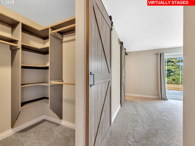 a view of walk in closet with empty racks