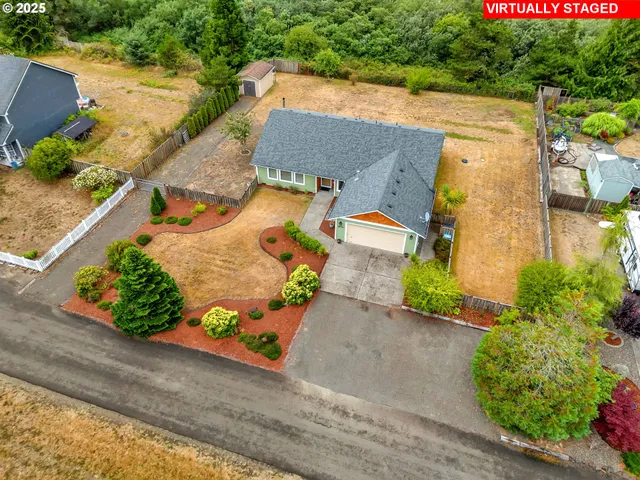 an aerial view of a house with a yard and a garage