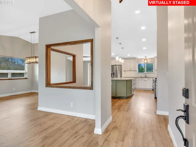 a view of a living room a kitchen and a wooden floor