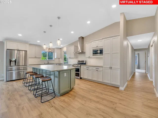 a kitchen with stainless steel appliances a refrigerator sink and cabinets
