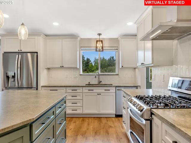 a kitchen with granite countertop a sink stove and refrigerator