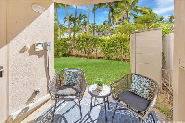 a view of a patio with table and chairs and potted plants