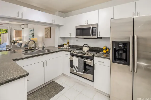 a kitchen with stainless steel appliances granite countertop a sink and a stove