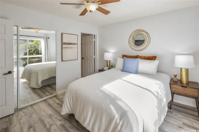 a bedroom with a bed and a ceiling fan