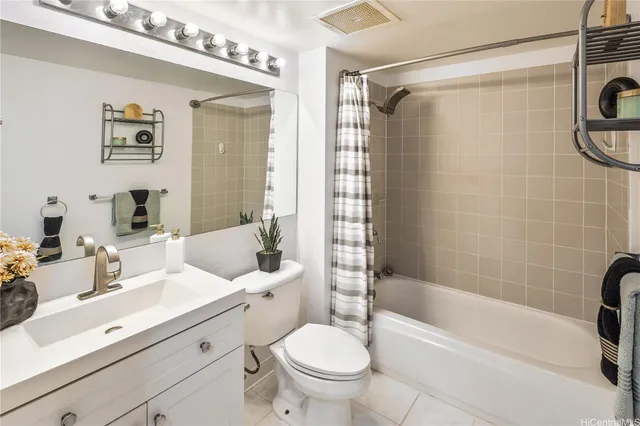 a bathroom with a sink a toilet a mirror a bathtub and shower