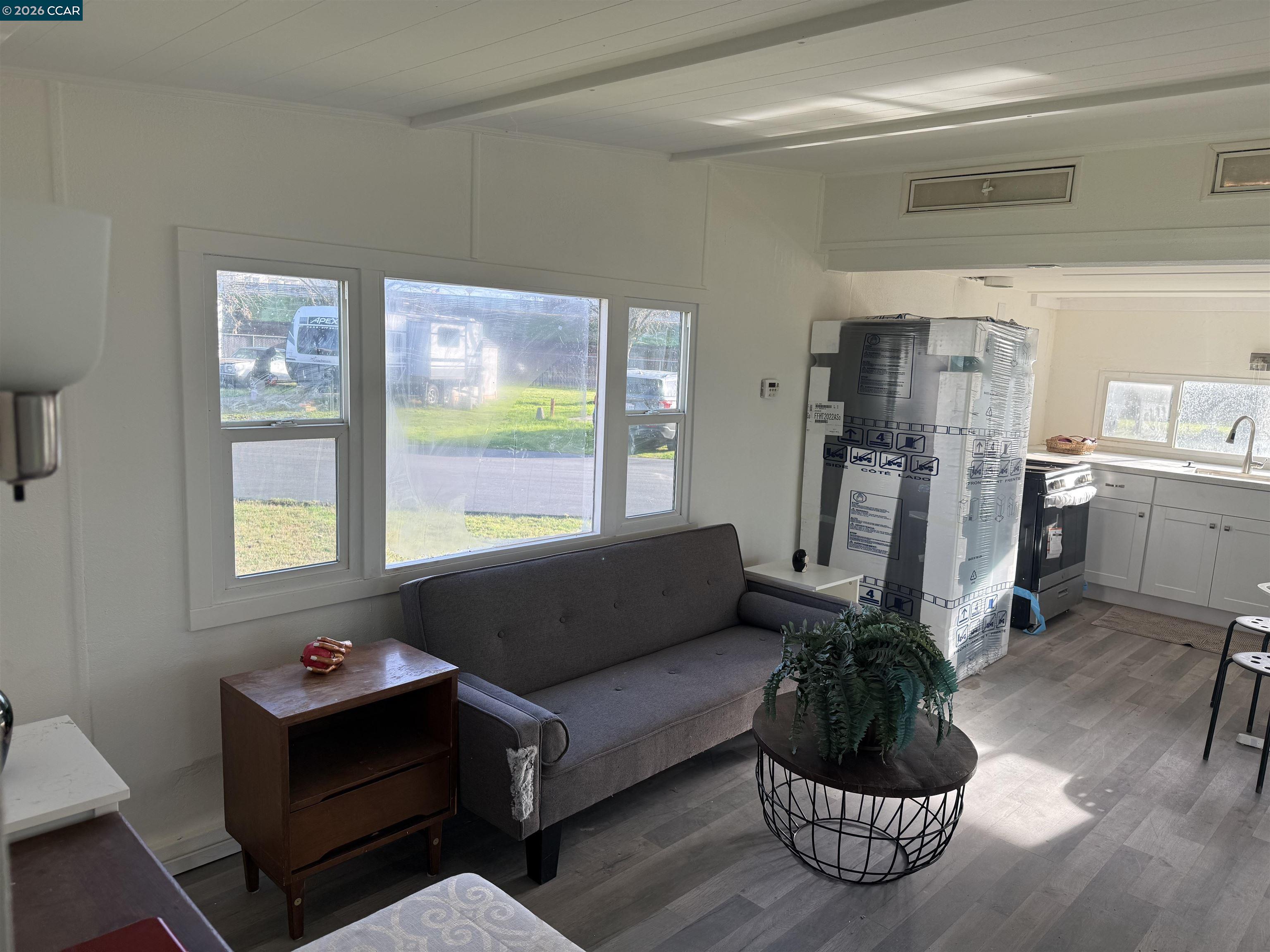 3505 Gateway Road, Unit 13M Bethel Island, CA 94511 - Photo 11 of 17 a living room with furniture and a large window